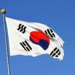 Trump CROWNED By Foreign Nation — UNPRECEDENTED Honor South Korean flag waving against a clear blue sky