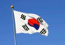 Trump CROWNED By Foreign Nation — UNPRECEDENTED Honor South Korean flag waving against a clear blue sky