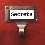 Eyewitnesses Expose Landlord’s Devious Cover-Up Metal label holder saying Secrets on wood background
