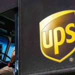 UPS delivery truck driver at traffic light