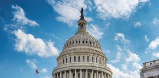 U.S. Capitol building dome under clear blue sky.