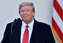 $2,000 Checks: Trump’s Bold Move Before Midterms Man in suit and tie speaking at podium.