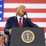 Trump’s Shocking Reversal on Epstein Files Man speaks at podium with U.S. flag background.