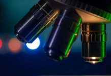 Closeup of microscope lenses with colorful background