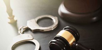 Handcuffs and judges gavel on the table