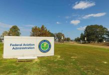 Federal Aviation Administration sign on grassy lawn.