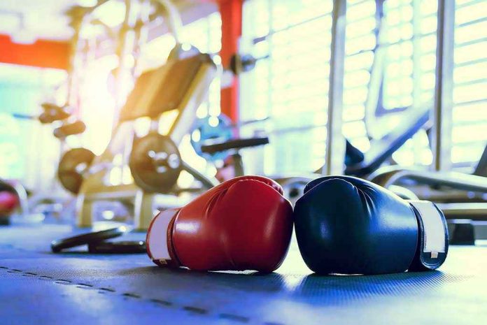 Boxing gloves on gym floor with equipment
