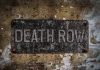 Flames Erupt in Controversial Execution Weathered Death Row sign on aged concrete wall