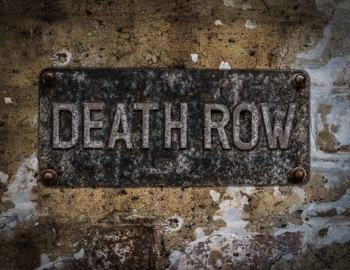 Weathered Death Row sign on aged concrete wall
