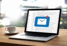 Ghislaine Maxwell Email Leak Sparks Constitutional Uproar Laptop with email notification on screen at desk