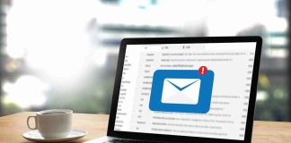 Laptop with email notification on screen at desk