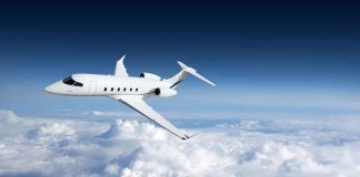 Private jet flying above the clouds