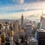 Aerial view of New York City skyline featuring the Empire State Building at sunset