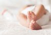 Court’s Stunning Sentence Hike for Baby Killer Close-up of baby feet lying on blanket.