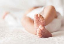 Court’s Stunning Sentence Hike for Baby Killer Close-up of baby feet lying on blanket.