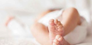 Court’s Stunning Sentence Hike for Baby Killer Close-up of baby feet lying on blanket.