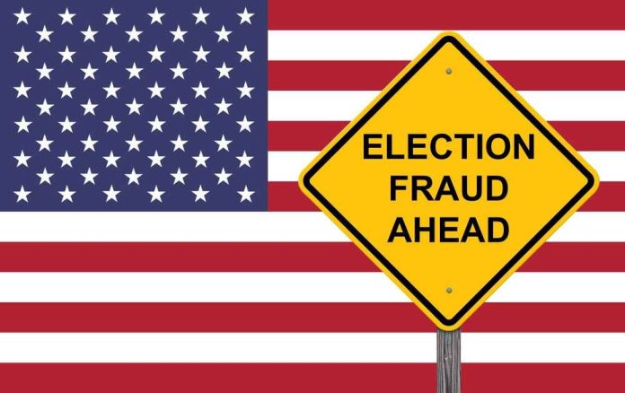 Yellow sign reading Election Fraud Ahead with American flag.