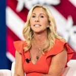 Congressional Pension SCANDAL – $38 Million Drain! Woman speaking at an event, wearing a red dress.