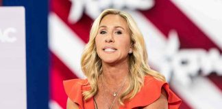 Congressional Pension SCANDAL – $38 Million Drain! Woman speaking at an event, wearing a red dress.