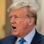 Shocking GOP Split: Trump Rejected Man in suit with open mouth, speaking passionately.