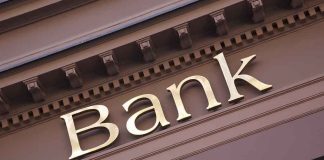 Gold bank sign on building facade