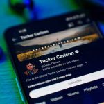 Loomer Accuses Tucker: Qatar’s Dark Ties Exposed Smartphone displaying a YouTube channel profile page.