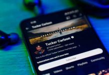 Loomer Accuses Tucker: Qatar’s Dark Ties Exposed Smartphone displaying a YouTube channel profile page.