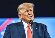 TRUMP’S SNAP SHOCKER: Aid Withheld from Key States Man in suit speaking at a microphone.