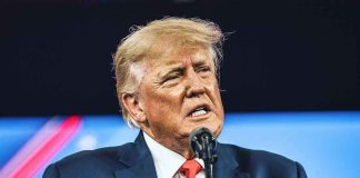 TRUMP’S SNAP SHOCKER: Aid Withheld from Key States Man in suit speaking at a microphone.