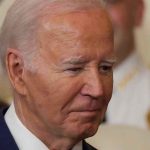 Biden’s $2.68B Bomb Deal Sparks Outrage Man in a suit looking thoughtful.