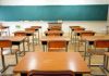 Horrific Child Charges: Substitute Teacher ARRESTED Empty classroom with desks and a chalkboard.