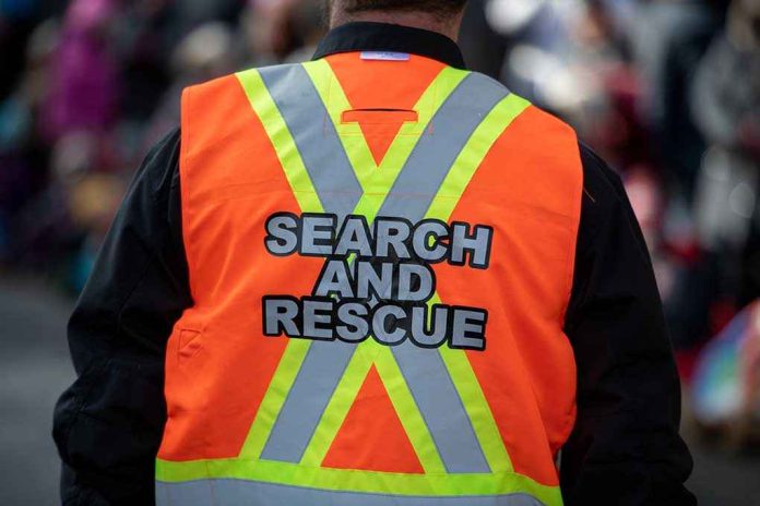 shutterstock_1576127386 (2).jpg Person wearing a bright orange search and rescue vest