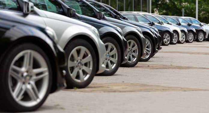 shutterstock_227900236.jpg A row of parked black and silver cars in a dealership