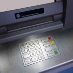 Close-up of an ATM keypad with numeric buttons and function keys
