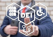 Person pointing at DEI symbols on glass.