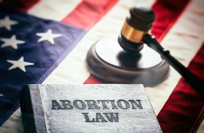 2182069301 Abortion law book, gavel, and American flag.