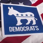 7 Democrats Defect–Stun Party! Democrats logo on American flag background