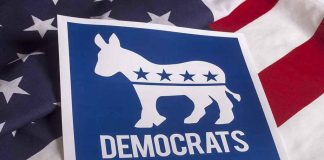 7 Democrats Defect–Stun Party! Democrats logo on American flag background