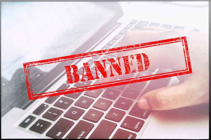 Red Banned stamp over a laptop keyboard.