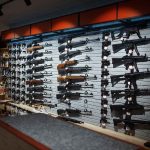 Wall-mounted guns displayed in a store.