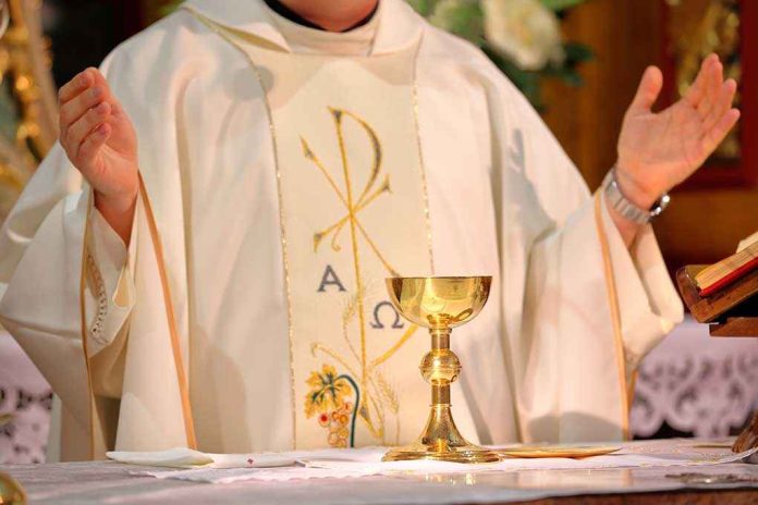 A priest holding a golden chalice during a religious ceremony