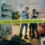 Race Dilemma: Assault Case Ignites Tension Crime scene with tape and investigators examining evidence.