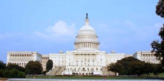 View of the U.S. Capitol building with a security barrier in front