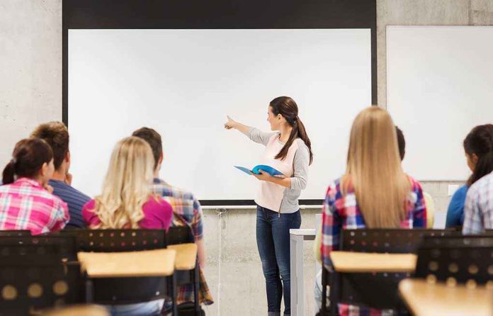 shutterstock_220706344-1 A teacher presenting to students in a classroom