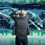 Gold Just Sent A Dire Warning Person in front of falling stock market graph.