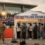 Polling station with military personnel and voters in line