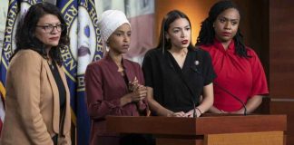 Four women politicians speaking at a press conference