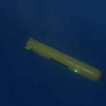Stealth Sub Launches Drones Underwater Autonomous underwater vehicle gliding in deep blue water