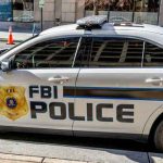 Clinton Ties Resurface In FBI File FBI police car parked on city street.