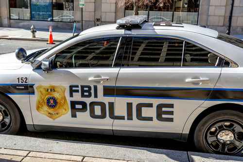 shutterstock_1674734854 FBI police car parked on city street.